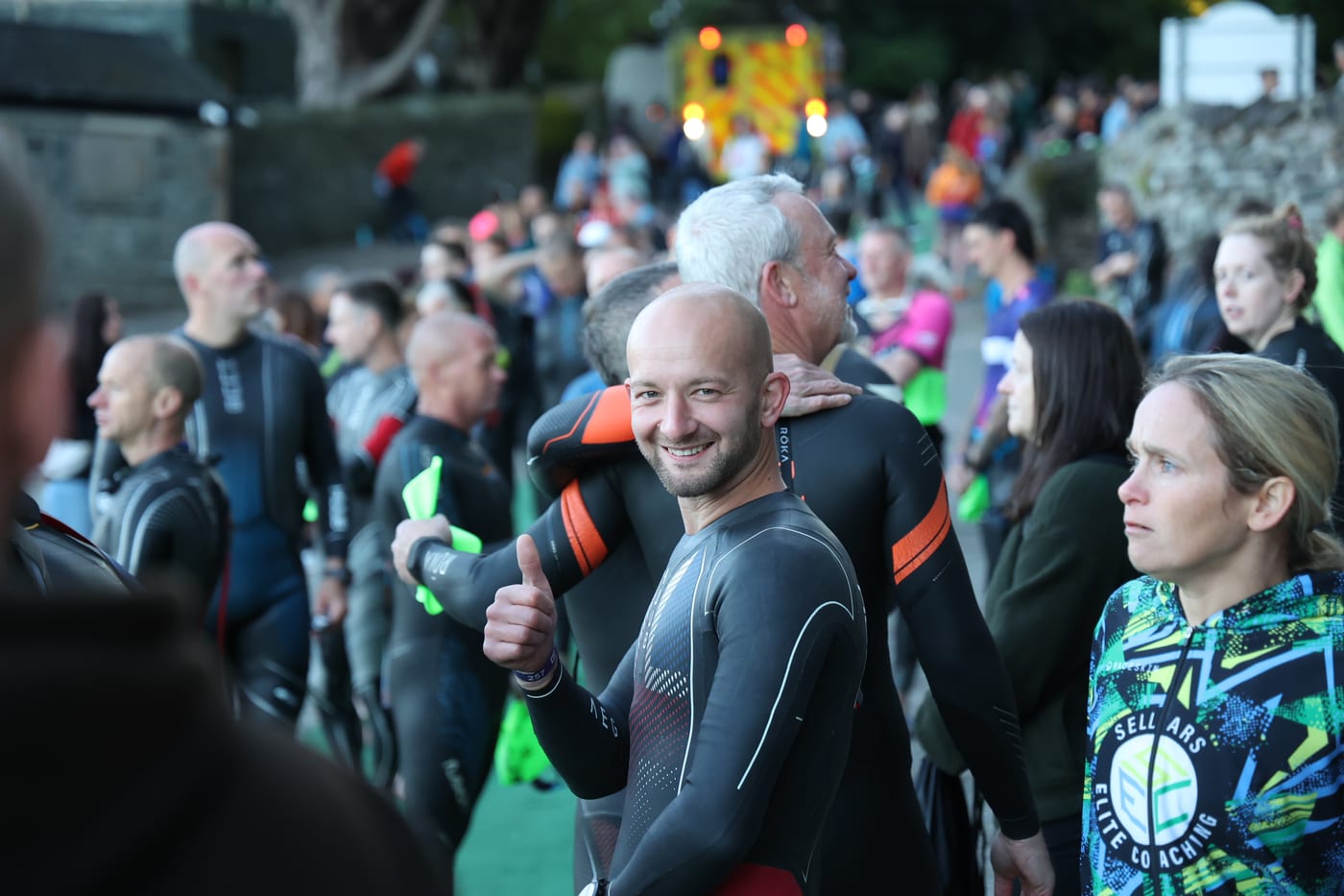 Athletes in wetsuits before the swim start