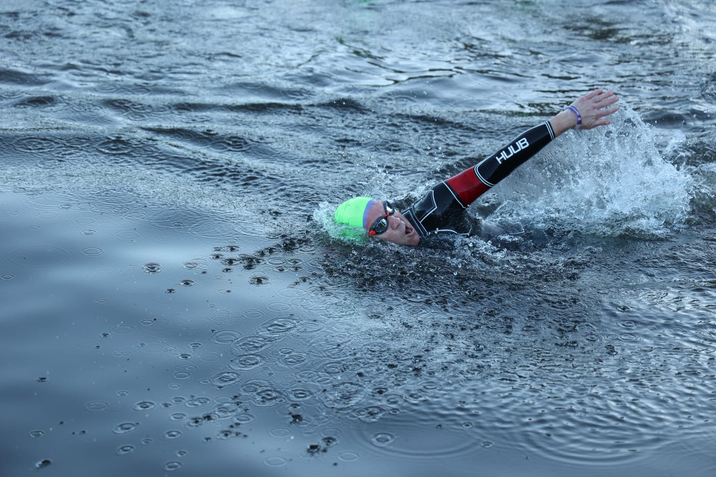 Swimmer in a green cap during the open-water swim