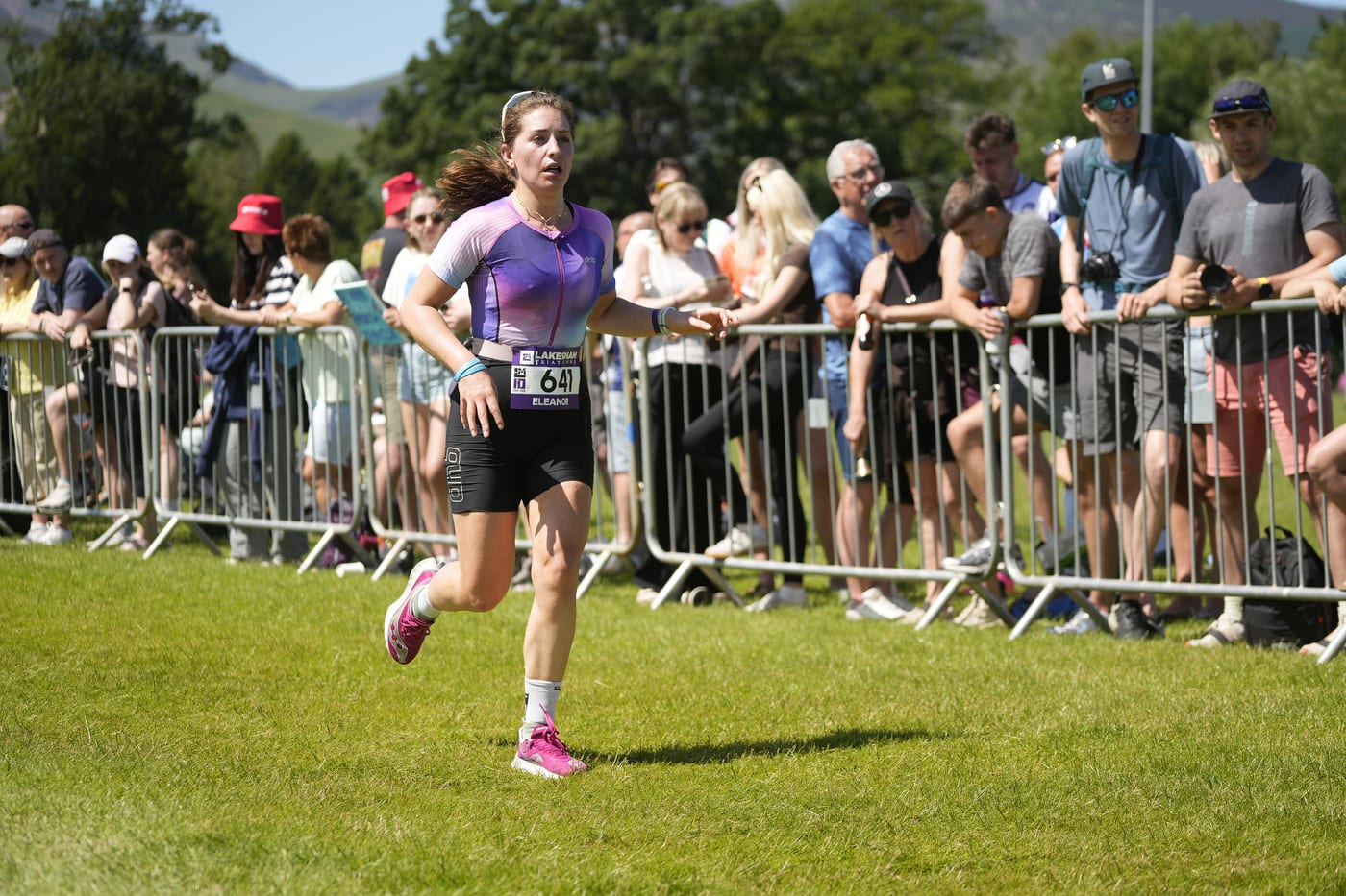Lakesman athlete on the run course cheered on by spectators